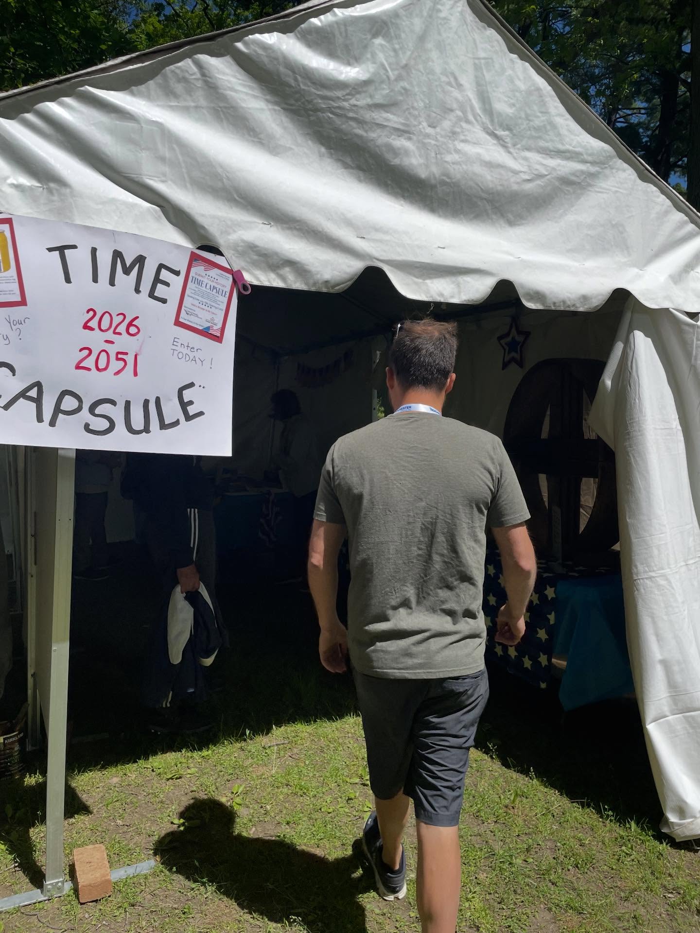 Visitor approaching a time capsule tent at a heritage festival